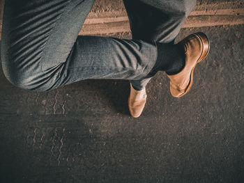 Low section of man sitting on floor