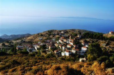 High angle view of townscape by sea against sky