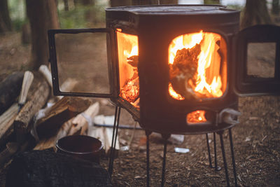 Winter camping. chopping wood with an axe and stoking the wood stove.