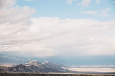 Scenic view of mountains against cloudy sky