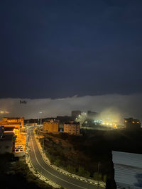 High angle view of illuminated buildings in city at night