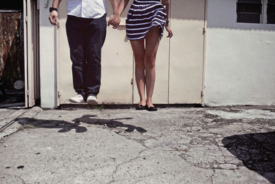 Low section of man with woman outside house