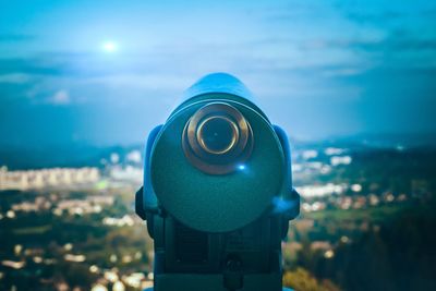 Close-up of coin-operated binoculars against sky