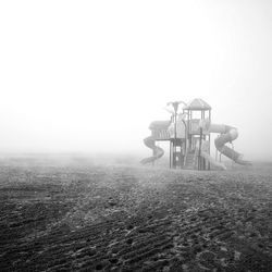 Lifeguard hut on field against sky