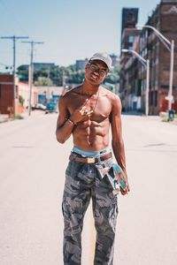 Portrait of young man standing on city street