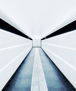 Empty white corridor in building