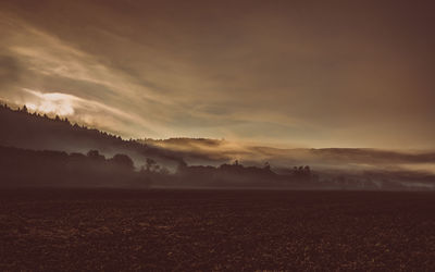 Scenic view of landscape against cloudy sky