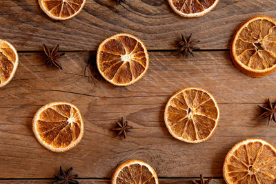 Christmas backdrop with dry oranges and anise stars on wooden background 