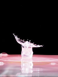 Close-up of water splashing over black background