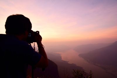 Man photographing at sunset