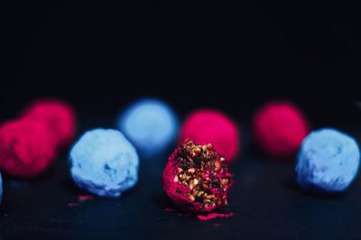 Close-up of candies on table against black background