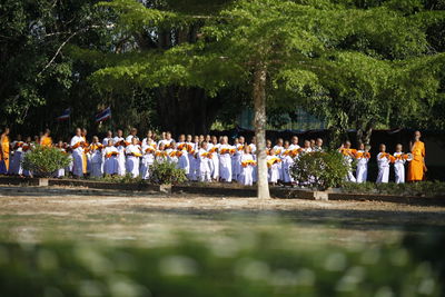 People in traditional clothing during ceremony