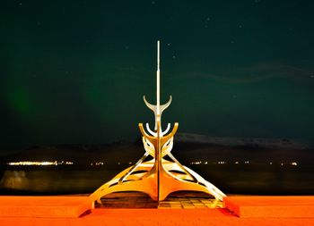 Traditional windmill against sky at night