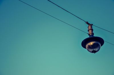 Low angle view of cables against clear blue sky