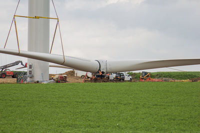 Traditional windmill on field against sky