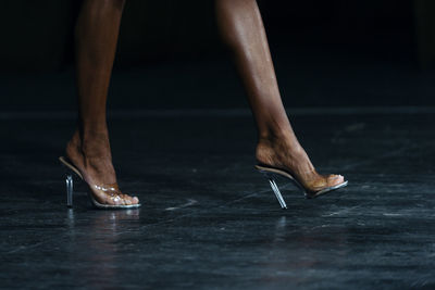 Low section of woman walking on floor