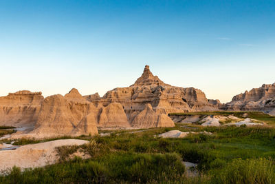 Rock formations on landscape against clear sky