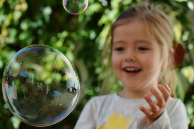 Close-up of boy holding bubbles