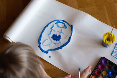 High angle view of cute girl playing with toys on table