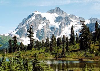 Scenic view of lake and mountains against sky