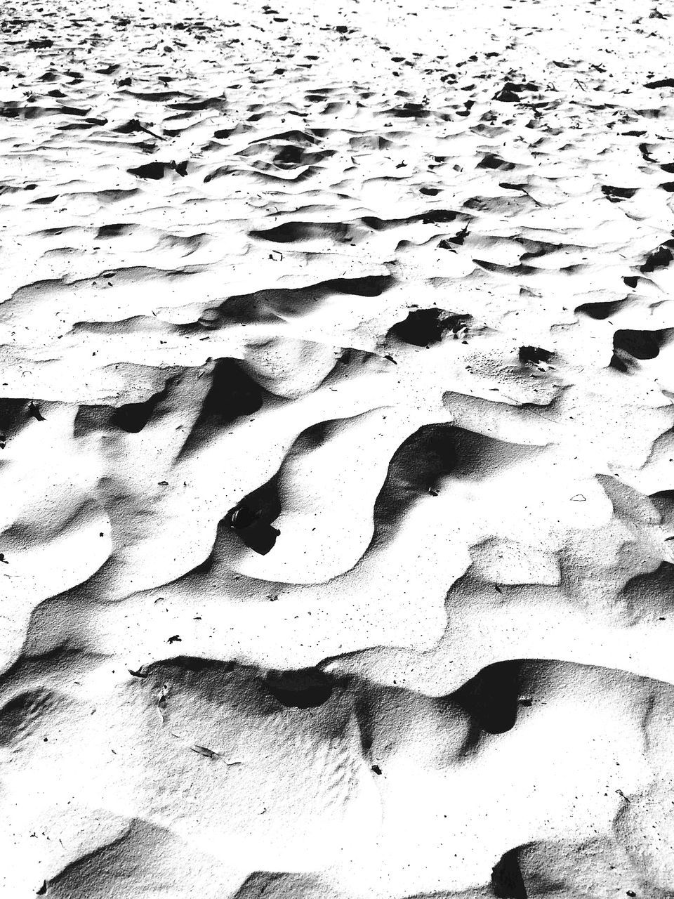 high angle view, water, nature, sand, rock - object, tranquility, full frame, day, outdoors, beach, backgrounds, textured, no people, sunlight, shore, rock formation, shadow, beauty in nature, natural pattern, rough