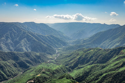 Misty mountain range covered with white mist and amazing blue sky