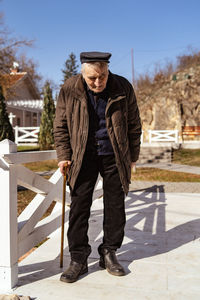 Full length of senior man standing outdoors