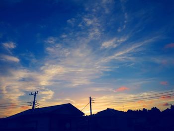 Low angle view of silhouette buildings against sky during sunset