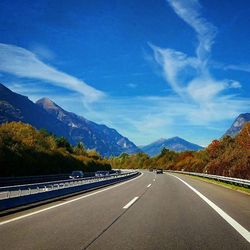 Empty road with mountains in background