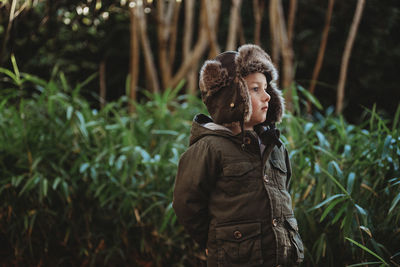 Man looking at camera in forest