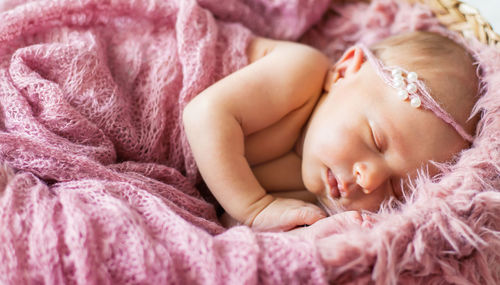 Cute baby sleeping in crib at home