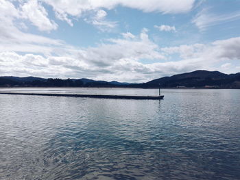 Scenic view of mountain range against cloudy sky