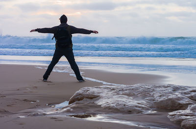 Full length of man standing on beach