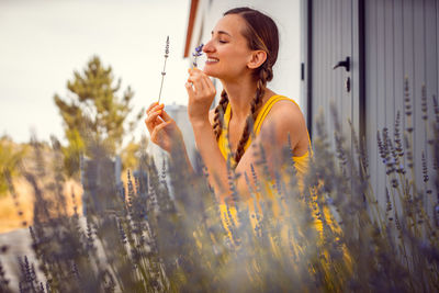 Young woman holding flowers outdoors