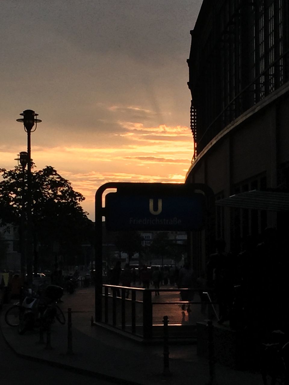building exterior, built structure, architecture, sky, tree, low angle view, sunset, car, transportation, mode of transport, city, land vehicle, house, silhouette, building, outdoors, cloud - sky, dusk, street light, no people