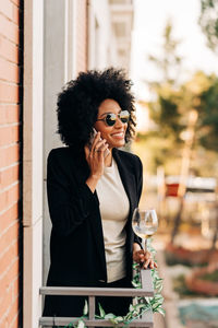 Young woman using mobile phone outdoors