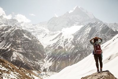 Tourists walking on snow covered landscape