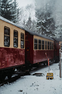 Train on snow covered railroad tracks during winter