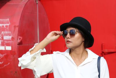 Close-up of woman wearing sunglasses and hat