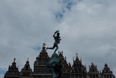 Low angle view of statue against cloudy sky