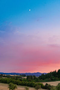 Scenic view of landscape against sky at sunset