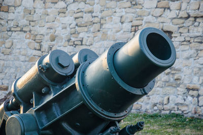 Close-up of machinery on brick wall