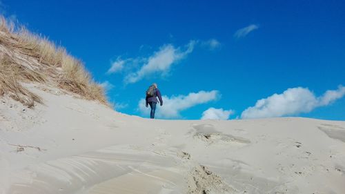 Full length of man against blue sky