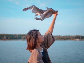 Portrait of happy woman against sky