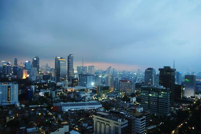 Illuminated cityscape against sky