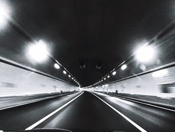 Illuminated tunnel at night