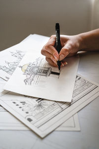 Hands drawing architecture and design