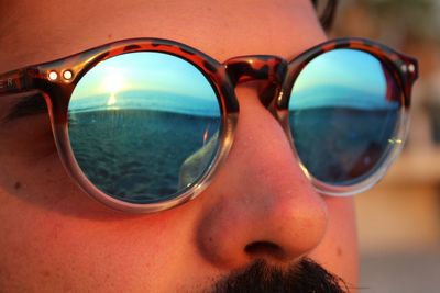 Close-up portrait of reflection of sunglasses