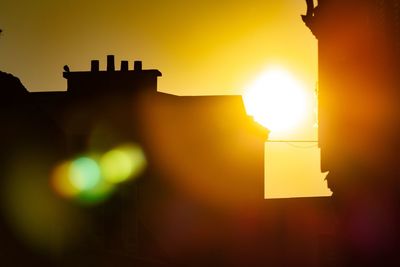 Low angle view of illuminated building against sky during sunset