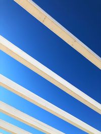 White wooden ceiling planks against blue sky